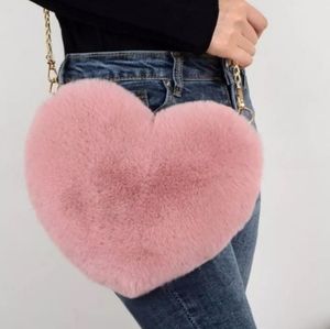 Faux fur fuzzy heart shaped mauve purse.